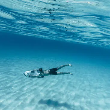 Snorkeller floating in clear turquoise waters at Amanyara.