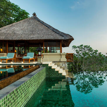 Three-bedroom villa with thatched roof overlooking tranquil waters at Amandari.