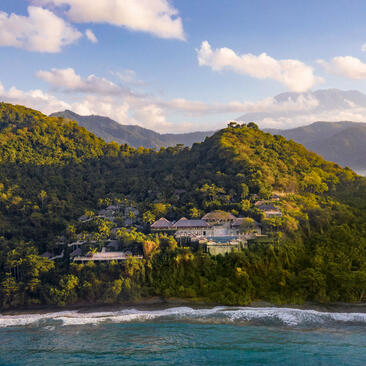 Amankila nestled on a lush hillside overlooking the Indian Ocean coastline in Bali.