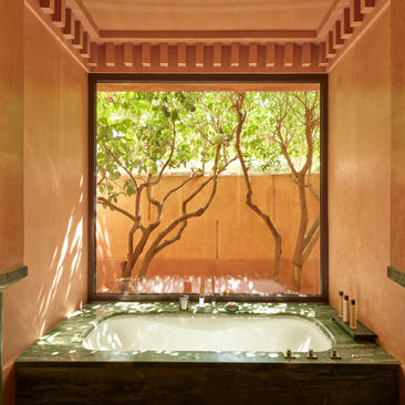 Pavillon bedroom with framed garden views at Amanjena resort.