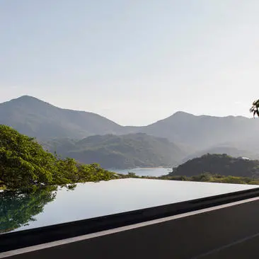 Four-bedroom villa at Amanoi with views over mountains and water.