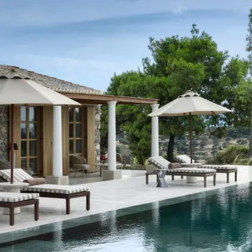 Villa with plunge pool and sunlit terrace at Amanzoe resort, Greece.