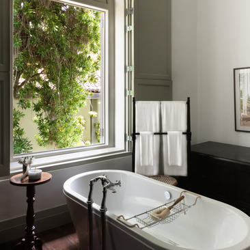 Principal bedroom bathroom at Amangalla with freestanding bath and garden views.