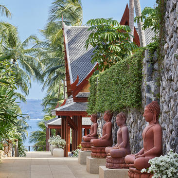 Villa 23 courtyard with traditional Thai sculptures and climbing vines, Amanpuri resort, Phuket.
