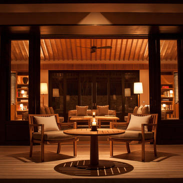 Villa living pavilion at Amanoi with warm-lit seating area and round table.