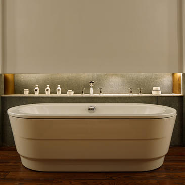 Freestanding oval bathtub in the Deluxe Suite bathroom at Amandayan, with minimal toiletries on the shelf above.
