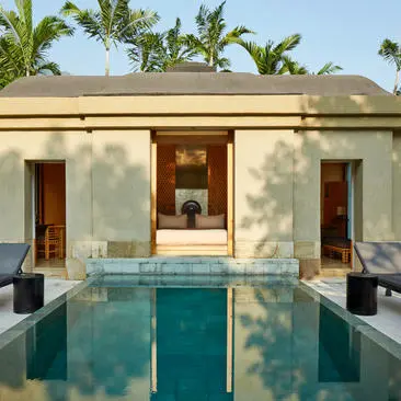 Pavilion with private pool at Amanjiwo resort, featuring cream-coloured walls, wooden doors, and turquoise water.