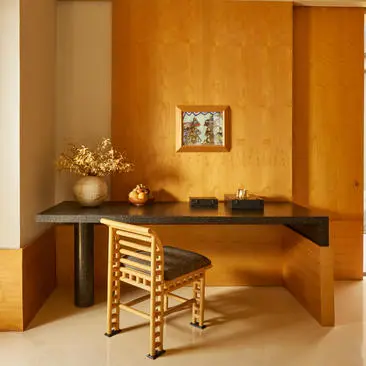 Suite desk at Amanjiwo resort, featuring warm wooden furniture and minimalist décor.