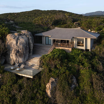 Amanoi's Pavilion Ocean Square perched on a rocky outcrop surrounded by verdant hillsides.