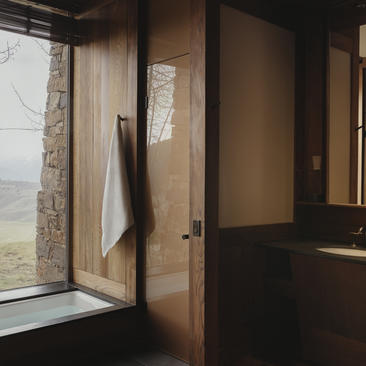 Wooden door and window frames at Amangani with views across the valley beyond.