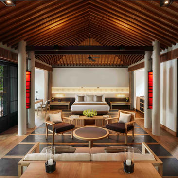 Ocean Pool Villa living area at Amanoi, featuring wooden ceiling and neutral furnishings.