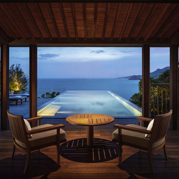 One-bedroom ocean pool residence at Amanoi with infinity pool overlooking the sea at dusk.