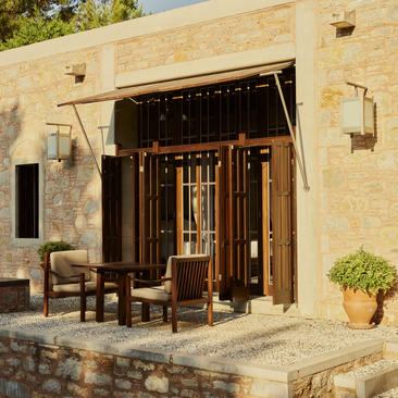 Deluxe sea view pavilion at Amanruya with wooden shutters, stone terrace and potted plants.