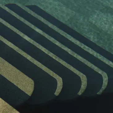 Amanruya pool with curved architectural lines casting shadows across still water.