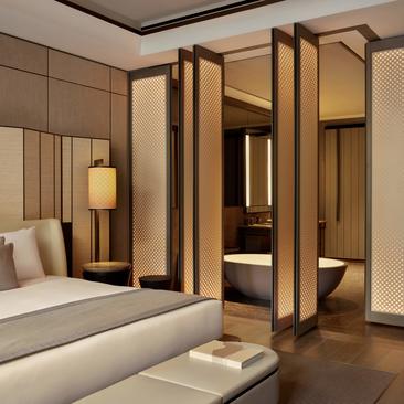 Premier Suite principal bedroom with wooden wardrobe at Aman New York, 57th Street.