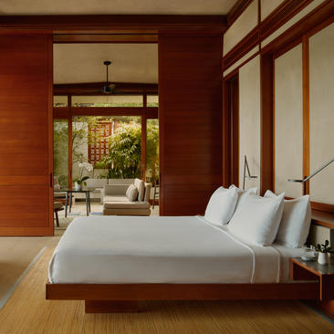 Principal bedroom in a Hill Casita at Amanera resort, Dominican Republic, with warm terracotta walls and garden views.