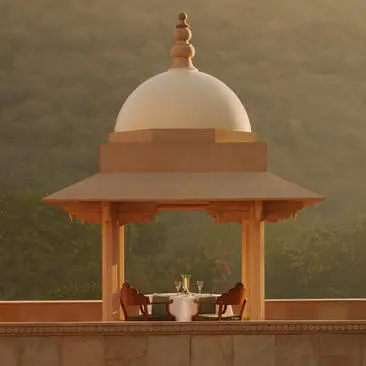 Amanbagh's main building exterior featuring a domed pavilion with terracotta columns and cream dome.