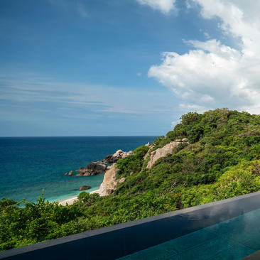 Amanoi ocean pool overlooking forested coastline and turquoise waters, Vietnam.