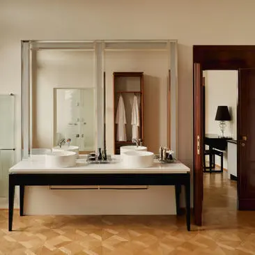 Bathroom with fresco details and double mirrors at Aman Venice.