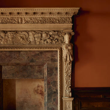 Ornate stone fireplace mantelpiece with carved classical detailing at Aman Venice.