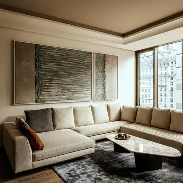 Modern one-bedroom living room at Aman New York with cream sectional sofa and city views.