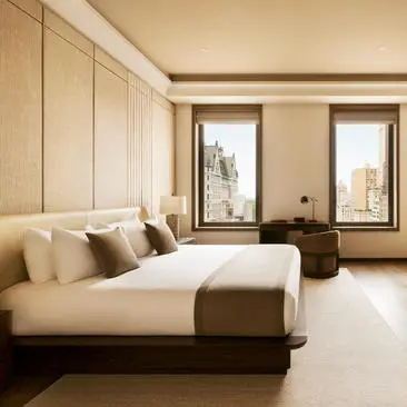 Three-bedroom residence at Aman New York with bed, windows, and city views.
