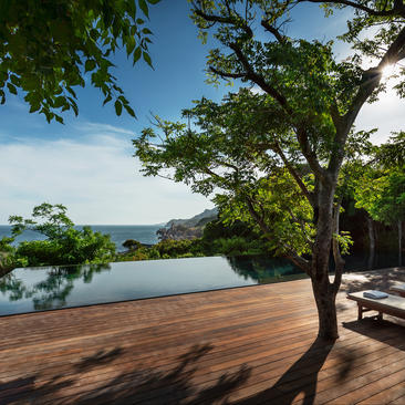 Wooden terrace with plunge pool overlooking coastal landscape at Amanoi, Vietnam.
