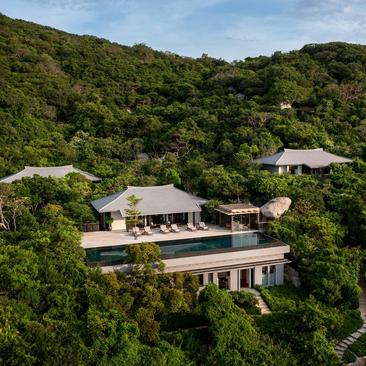 Aerial view of a residence at Amanoi nestled among forested hillside in Vietnam.