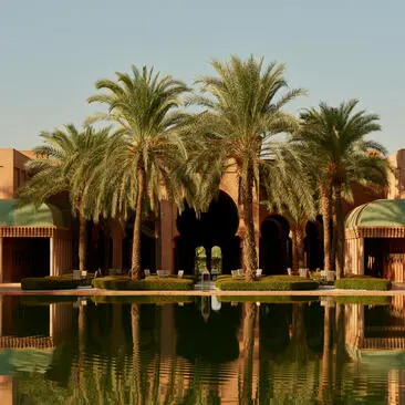 Central courtyard with reflecting pool and date palms at Amanjena, Morocco.