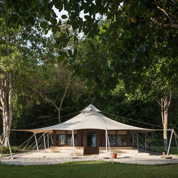 Jungle tent accommodation surrounded by lush greenery at Amanwana, Sumbawa, Indonesia.