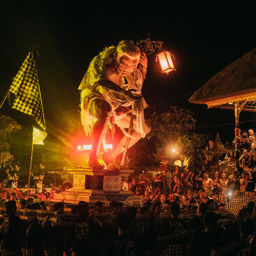 Nyepi celebration at Amandari resort in Ubud, with a large illuminated effigy surrounded by crowds during the Balinese New Year festival.