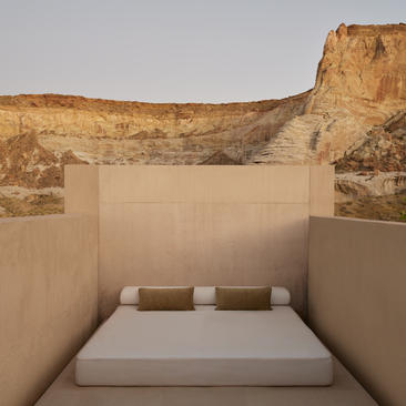 Girijaala Suite bedroom at Amangiri with bed facing canyon rock walls under open sky.