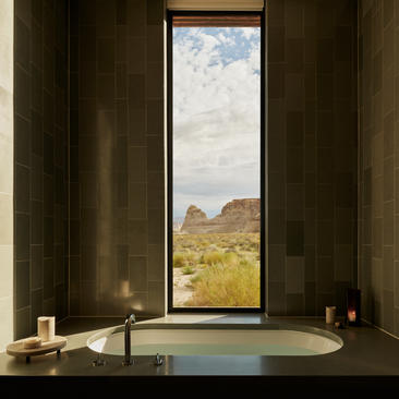 Mesa pool suite bathroom with soaking tub overlooking desert landscape at Amangiri.