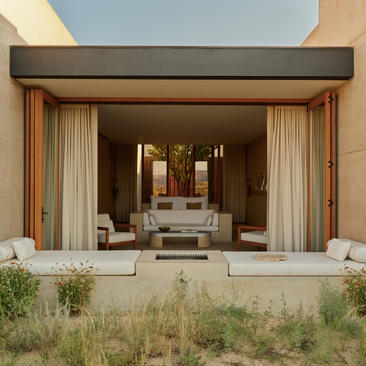 Desert pool suite at Amangiri with floor-to-ceiling curtains opening onto an arid landscape.