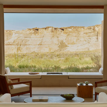 Mesa Suite at Amangiri resort with view of layered canyon walls framed by window.