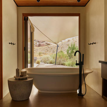 Freestanding stone bathtub with desert views at Amangiri's Camp Sarika accommodation pavilion.