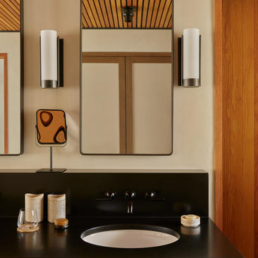 Camp Sarika accommodation pavilion bathroom with circular sink and wooden accents at Amangiri.