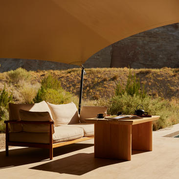 Breakfast pavilion seating area at Amangiri with wooden furniture and desert views.