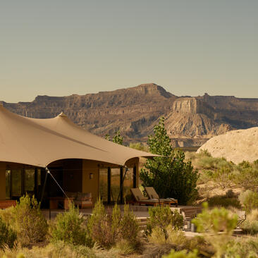Camp Sarika at Amangiri, with canvas tent and desert mountains at sunset.