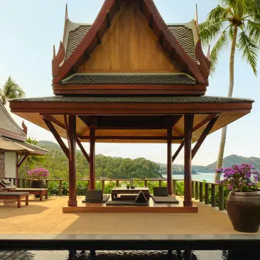 Deluxe ocean pool pavilion exterior at Amanpuri, Thailand, with traditional Thai architecture and verdant views.