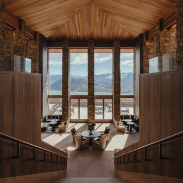 Amangani's lobby features wooden panelling and large windows framing views of Wyoming's landscape.