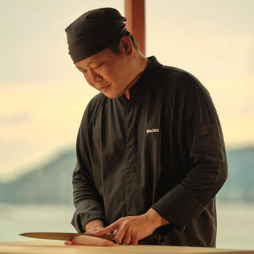 Chef slicing tuna at Nama sushi dining venue, Amanpuri resort, Thailand.