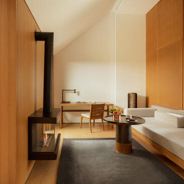 Ming Pavilion bedroom at Amanyangyun with wooden interior, fireplace, and contemporary furnishings.