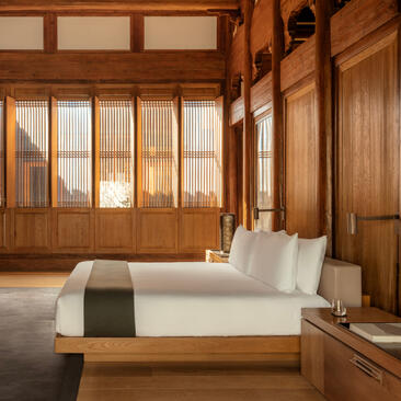 Principal bedroom with wooden panelling and four-poster bed at Amanyangyun, Shanghai.