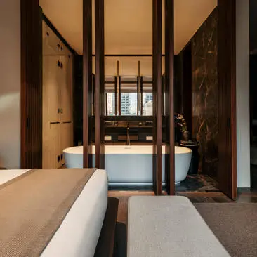 Principal bedroom with four-poster bed and view of New York City skyline at Aman New York.