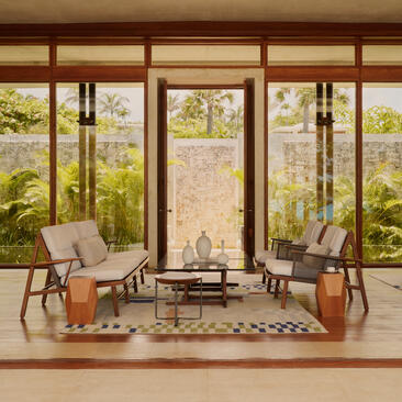 Two-bedroom Casa at Amanera with floor-to-ceiling windows overlooking gardens and seating area.