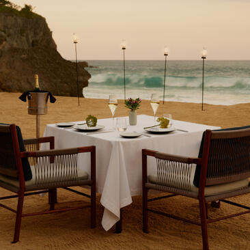 Dining table set for two at Amanera's beach club, overlooking the Dominican Republic shoreline.