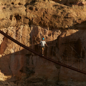 Climber on via ferrata route at Amangiri, Utah.