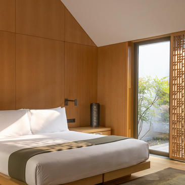 Ming-style courtyard guest room at Amanyangyun with wooden panelling and platform bed.