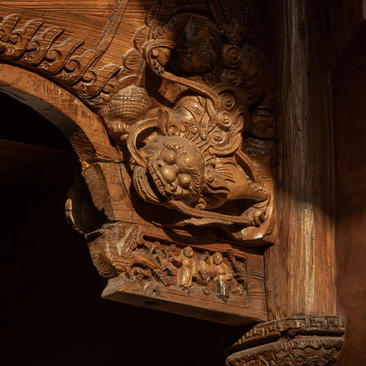 Carved wooden architectural detail at Amanyangyun, China, featuring ornate dragon motif.